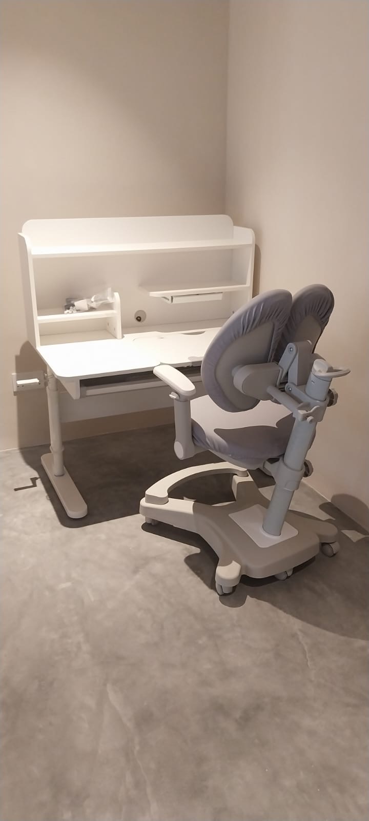 Ergonomic study desk and chair freshly assembled in a room