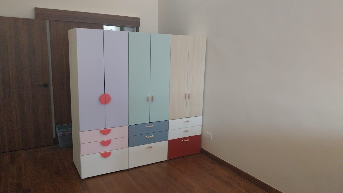 Large pastel wardrobe system assembled in a bedroom