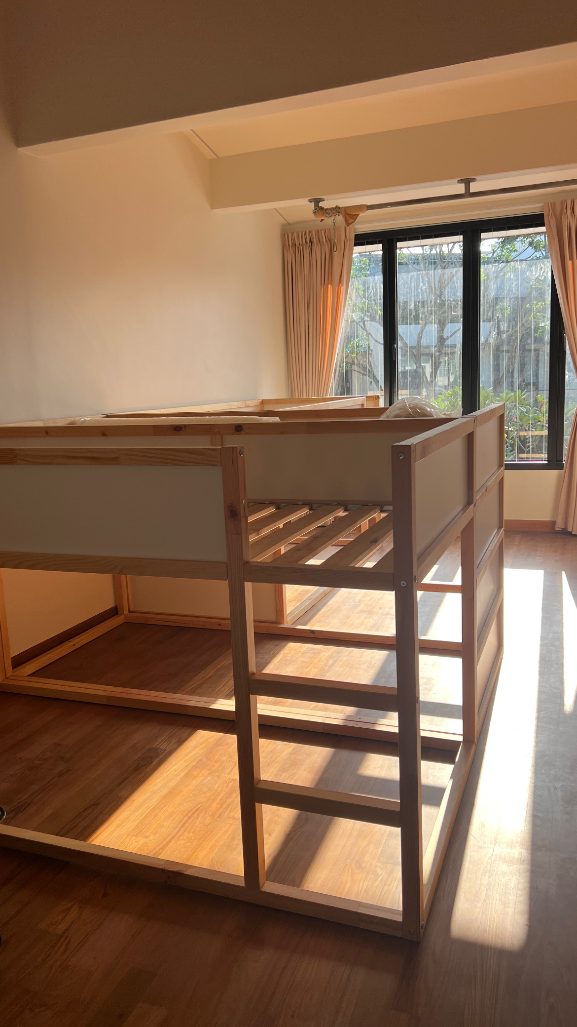 Pine loft bunk bed frame assembled in a bright room